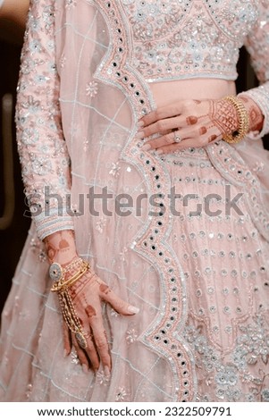 bride wearing bangles hand closeup bride getting ready for wedding ceremony Royalty-Free Stock Photo #2322509791