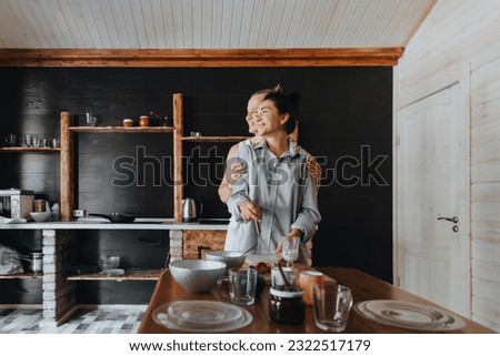 Young couple in love cook healthy food in the kitchen together. While laughing and talking.