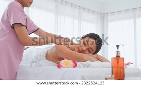 Young woman having massage in the spa salon. Spa for relaxation in modern wellness center.