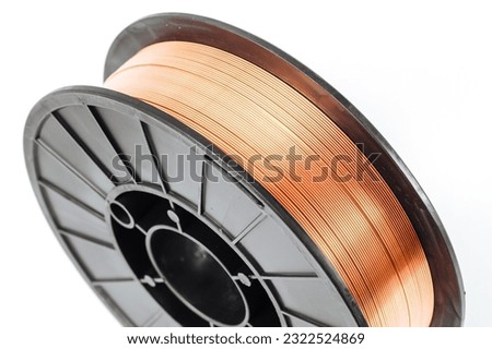 Welding wire spool on a white background. Royalty-Free Stock Photo #2322524869