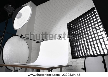 Interior of modern photo studio with professional equipment, low angle view