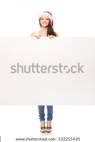 Young and attractive teenager girl with a blank billboard isolated on white background