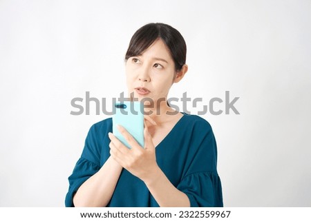 Asian middle aged woman with the smartphone thinking in white background round