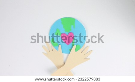Green globe planet eco concept. Earth day postcard close up. Stop motion paper animation. Pink heart beating. Ecology concept. Hands hold love sign. People show hug gesture. Whole world art card.