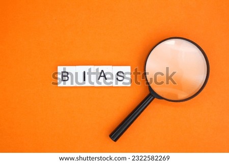 magnifying glass and letters of the alphabet with the word BIAS. inclination or prejudice for or against one person Royalty-Free Stock Photo #2322582269