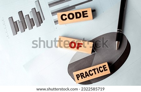 CODE OF PRACTICE wooden block on a chart background