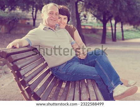mature man with a woman sitting on Royalty-Free Stock Photo #2322588499