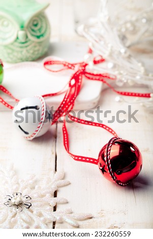 Christmas, New Year balls with ribbon with decorative snowflakes and owl on a white wooden background.