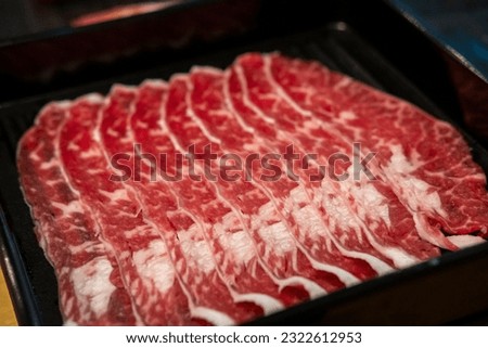 Close up of sliced oyster blade, raw meat ready to be cooked by hot pot Royalty-Free Stock Photo #2322612953