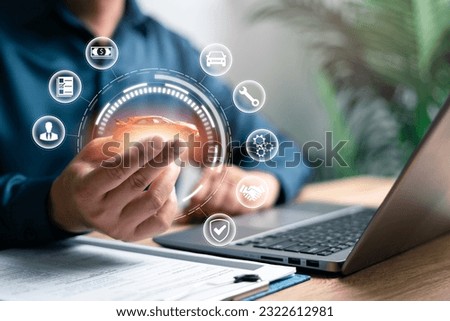 Car insurance and warranty concept, Businessman hold car models with insurance and car warranty icons on virtual screens financial and service insurance online technology  Royalty-Free Stock Photo #2322612981