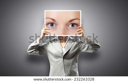 Unrecognizable businesswoman holding big photo with eyes