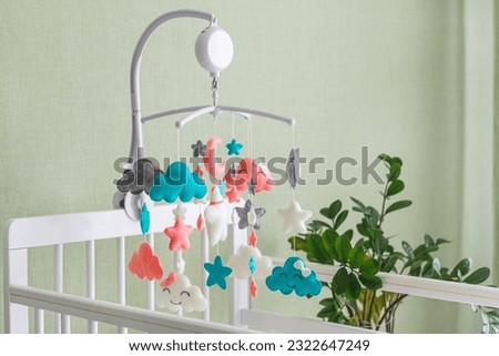 Baby crib mobile. Toys above the baby crib. Hanging soft clouds, stars and moon for the child. Royalty-Free Stock Photo #2322647249