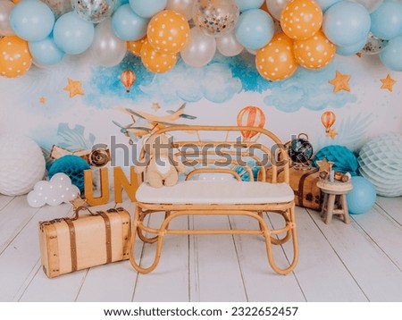 first birthday photo session in a photo studio with balloons and travel theme