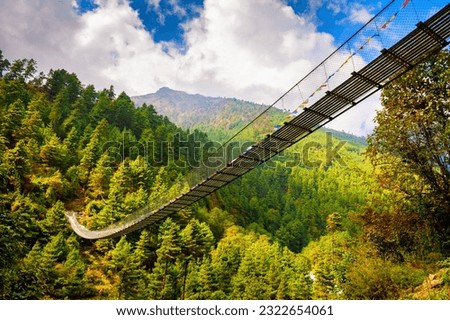 Suspension bridge in Himalaya mountains, Nepal. Khumbu valley, Everest region, Sagarmatha national park. Summer landscape Royalty-Free Stock Photo #2322654061