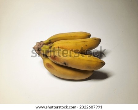 Banana "baby" a little bit rotten on white background
