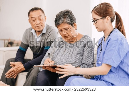 Senior elderly family sign contract medical consent form document with nurse doctor medical staff for financial or donation Royalty-Free Stock Photo #2322693323