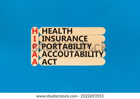 HIPAA symbol. Concept words HIPAA health insurance portability accountability act on wooden stick. Beautiful blue background. Business HIPAA health insurance portability accountability act concept.