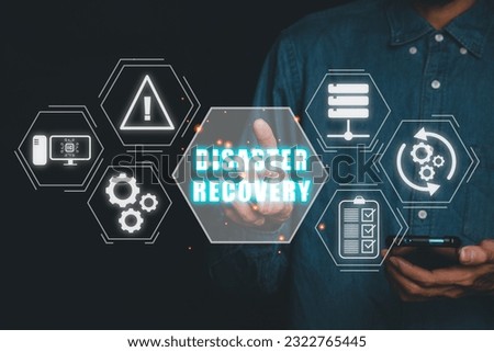 Disaster Recovery concept, Person hand touching disaster recovery icon on virtual screen background, Data loss prevention. Royalty-Free Stock Photo #2322765445