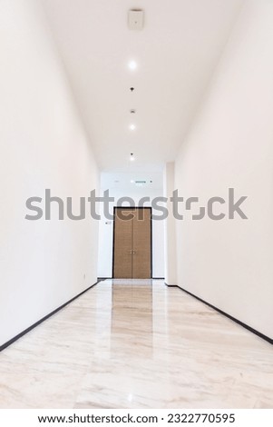 Clean and bright corridor with a door at the end