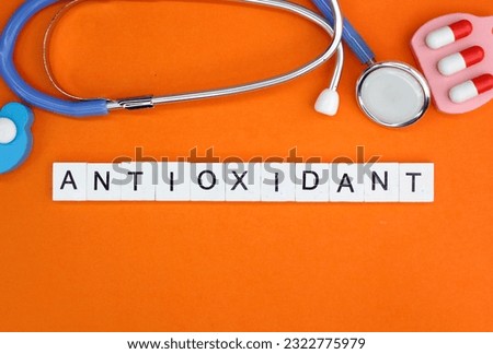 stethoscope and medicine with antioxidant alphabet word. the concept of health and healthy eating Royalty-Free Stock Photo #2322775979