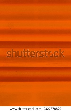 Close-up zoomed-in yellowish-orange thin fabric as the background of horizontal blinds. The natural light in the morning looked beautiful, creating a profound calm mood.