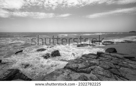 Photo of Mooloolaba Beach in Black and White with surf waves crashing over rocks