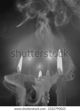 Three candles illuminate a smoky gray background.