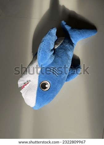 A delightful image capturing the charm of a baby shark plush toy basking in the morning sunlight