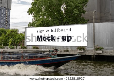 Mock up large advertising billboard with clipping path at corridor white screen view empty space for advertising on wall near corridor foreground is a boat by canal in Bangkok, Thailand