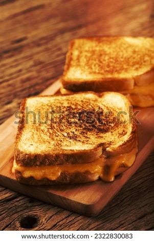 Grilled ham and cheese. Sandwich with cheese and ham on grill. Royalty-Free Stock Photo #2322830083