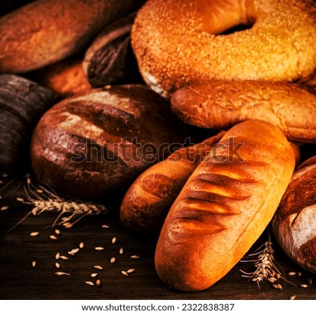 Different kinds of delicious bread. On a wooden background. High quality photo