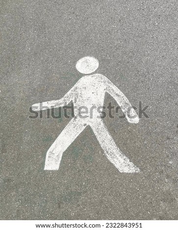 A walking sign painted in the road