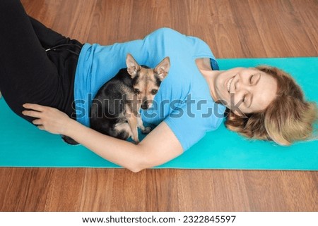 Fit and fun,Woman and dog on yoga mats, Yoga exercise with a cute pet