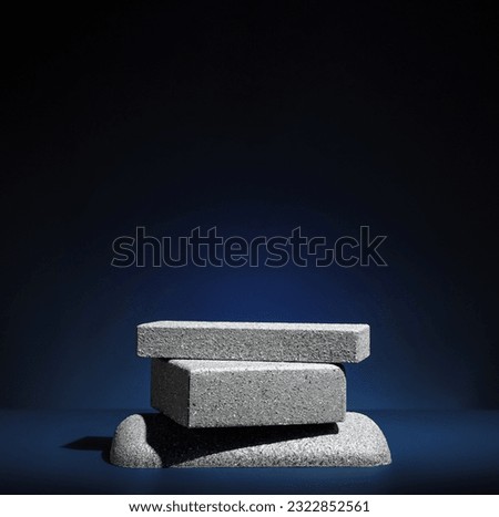Stone block pedestal stage product display background on navy color.zen like backdrop Royalty-Free Stock Photo #2322852561