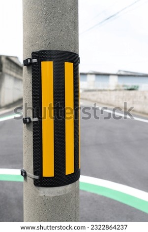 Electric pole signboard. Safety sign attached to an electric pole. Accident prevention. Tiger-patterned cover.