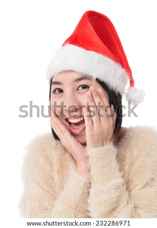 Portrait of pretty young woman in santa costume smiling over white background