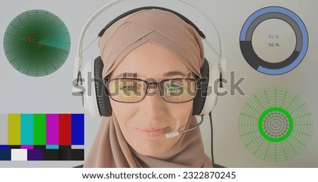 Gamer girl in hijab talking in headphones with microphone. Diagram, radar, reflection of symbols in glasses. Concept of online games, connections, internet.