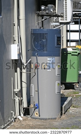 Heat pump hot water system at the back of a building Royalty-Free Stock Photo #2322870977