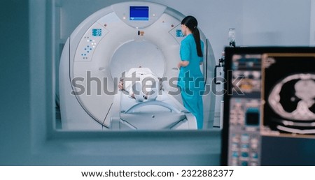 Nurse send patient to MRI capsule on moving table. Magnetic resonance imaging of brain. Room of examinaning with medical equipment. Royalty-Free Stock Photo #2322882377