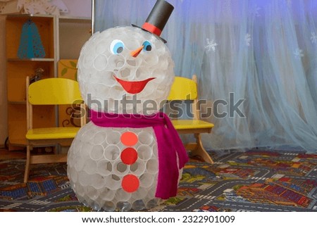snowman in kindergarten,a large snowman made of plastic cups, a great toy for the winter holiday