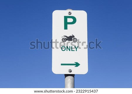 motorcycle parking sign against blue sky