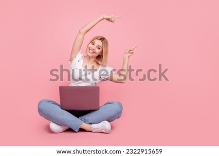 Full length size cadre of young marketer woman blonde direct fingers empty space with netbook settings isolated on pink color background