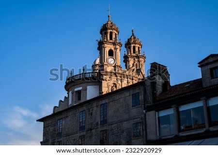 Bell tower of the Pilgrim Virgin church between old buildings. Photograph taken in Pontevedra, Galicia, Spain. Royalty-Free Stock Photo #2322920929