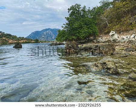 seaside atmosphere with rocks, currents and waves on the seafront, harbor village of Sangoro l, sumbawa Indonesia. Royalty-Free Stock Photo #2322926255