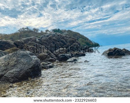 seaside atmosphere with rocks, currents and waves on the seafront, harbor village of Sangoro l, sumbawa Indonesia. Royalty-Free Stock Photo #2322926603
