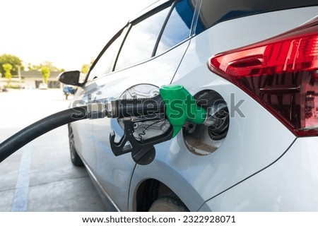 Green gas pump for refueling car on gas station.Green fuel, gasoline dispenser in station.The driver refuel at the petrol station.Save energy concept. Royalty-Free Stock Photo #2322928071