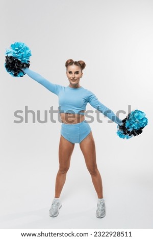 Dancing athletic cheerleader in a blue suit on a white background