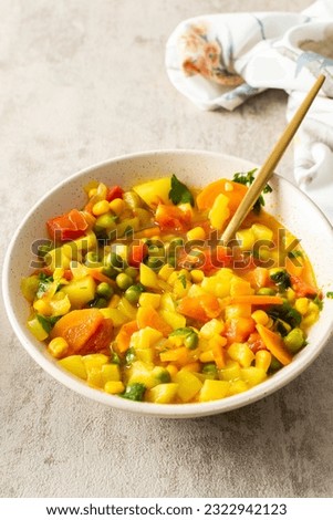 Minestrone soup from zucchini and tomato, onion and carrots, corn and peas with parsley, a plate of soup close-up, vegetarian soup Royalty-Free Stock Photo #2322942123