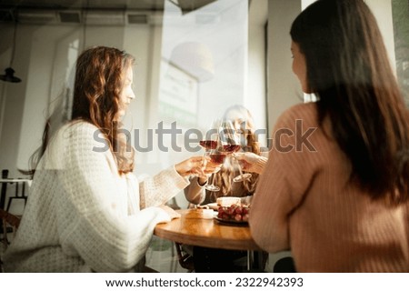 Developing taste, delicious food and drinks. Close-up image of wine glasses, clinking. Nice friends meeting at cafe on warm sunny day. Concept of party, celebration, taste, alcohol. Copy space for ad