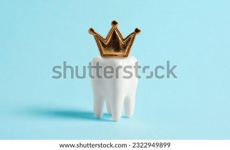 Tooth in the crown on blue background.